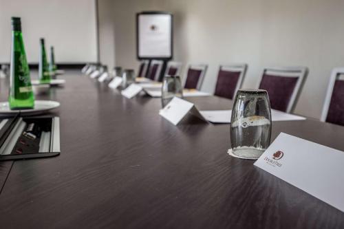 a long table with empty glasses on top of it at DoubleTree by Hilton Hotel Nottingham - Gateway in Nottingham