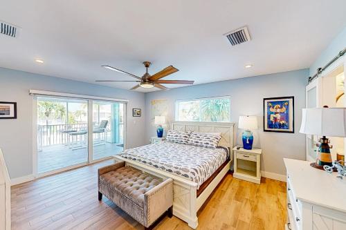 a bedroom with a bed and a ceiling fan at Tollgate Tides in Islamorada