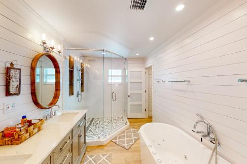 a bathroom with a shower and a tub and a sink at Tollgate Tides in Islamorada