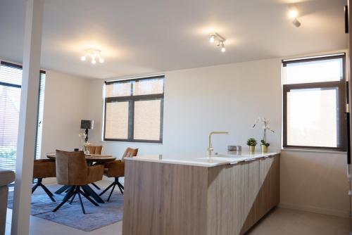 a kitchen with a counter and a dining room at Brand New Apartment Sint-niklaas in Sint-Niklaas