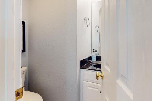 a bathroom with a toilet and a sink at Bear Trap Dunes --- 34 Sycamore Street in Ocean View