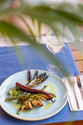a plate of food on a table with a glass of wine at The Grand Hotel in Punta del Este