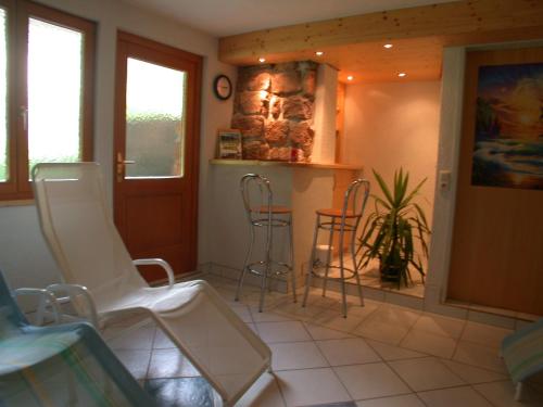 a room with chairs and a bar in a house at Appartement-Pension Familie Gewessler in Bad Mitterndorf