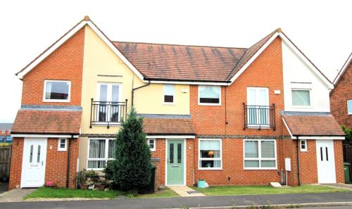 a row of brick houses in a street at 2 Bedroom House - Beautifully Decorated & Furnished - Parking - Large Garden in Ashington