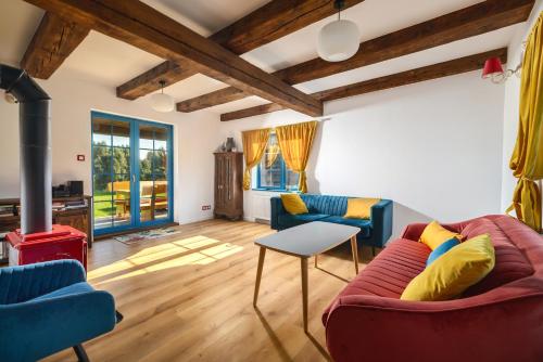 a living room with two couches and a fireplace at Kaszuby, dom kaszubski nad jeziorem Danielowa Dolina in Szymbark