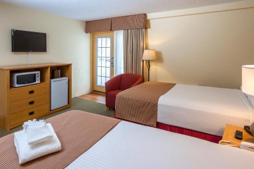 מיטה או מיטות בחדר ב-Sun Lodge