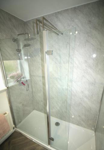 a shower with a glass door in a bathroom at 2 Bedroom House - Beautifully Decorated & Furnished - Parking - Large Garden in Ashington
