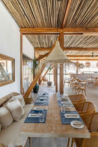 a long wooden table in a room with a couch at The Grand Hotel in Punta del Este