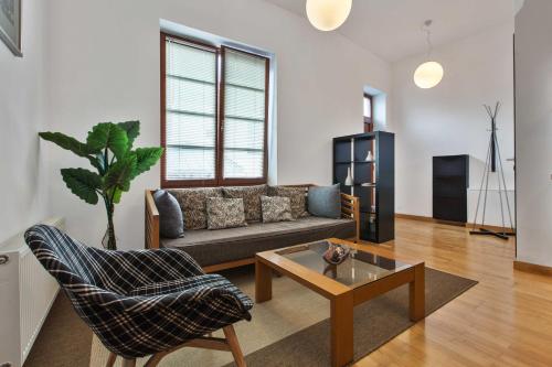 a living room with a couch and a coffee table at Dolná 4 - apartmány v priamom centre na námestí in Banská Bystrica