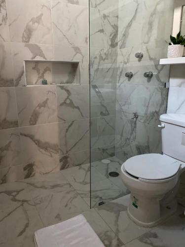 a bathroom with a toilet and a glass shower at Casa Mercedes in Valladolid