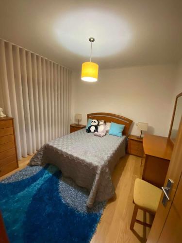 a bedroom with two stuffed animals sitting on a bed at Casa da Leonor in Viseu