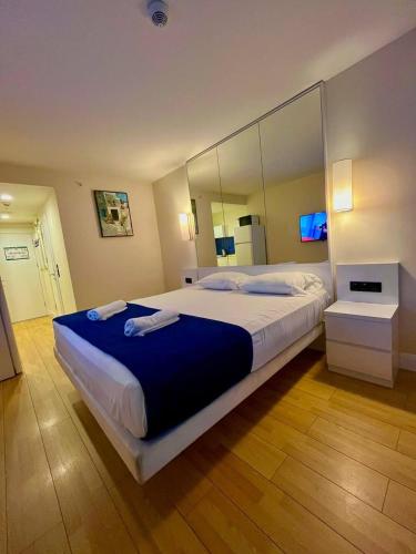a bedroom with a large bed with a large mirror at Orbi city sea view apartments in Batumi