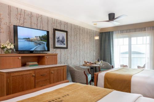 a hotel room with two beds and a television at Bar Harbor Inn and Spa in Bar Harbor