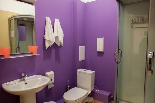 a purple bathroom with a toilet and a sink at HOTEL 19 in Samara