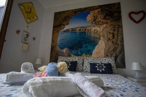 a bedroom with a bed with a picture of the ocean at Oasi della pace in Bisceglie