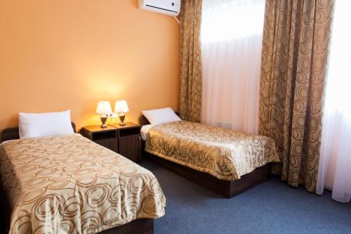 a hotel room with two beds and a window at HOTEL 19 in Samara