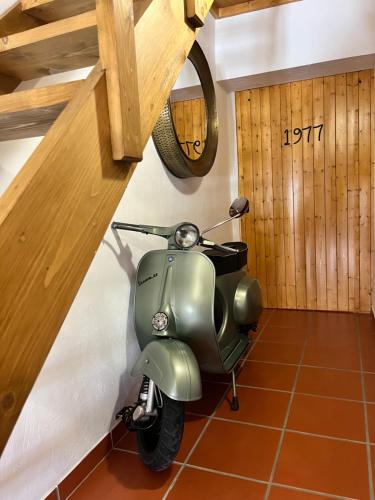 a green scooter is parked in a room at Vespa House in Igrejinha