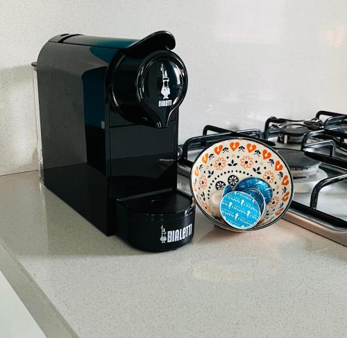 a coffee maker and a bowl on a stove at Console Flaminio apartment in Milan