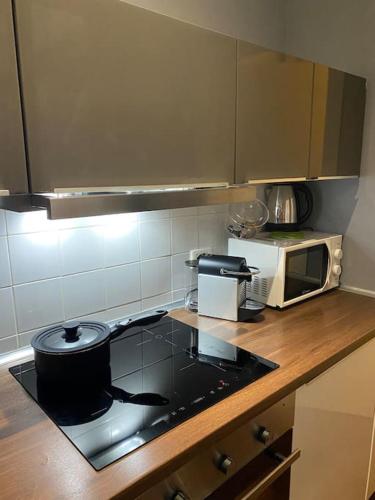 a kitchen with a stove top and a microwave at 2SanSiro in Genova