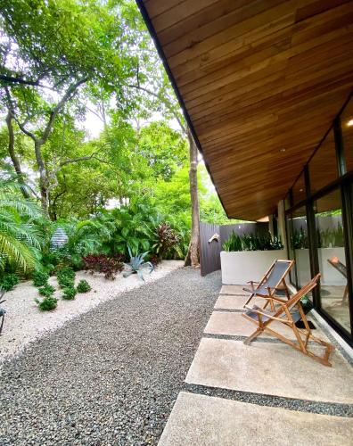 a patio with a folding chair on the side of a house at Villas Kalei in Playa Grande