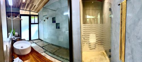 a bathroom with a shower and a toilet at Villas Kalei in Playa Grande