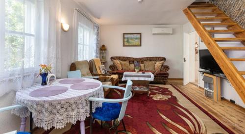 a living room with a table and a couch at Türi Holiday Home, a simple house in Türi