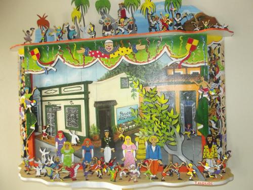 a framed picture of a family in a house at Pousada Alto Astral in Olinda