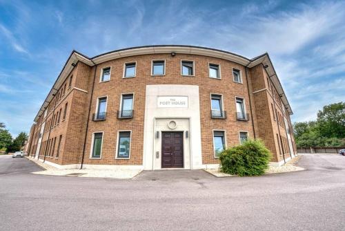 a brick building with a door in front of it at The Post House Green by Fortuna Property Portfolio in Gloucester