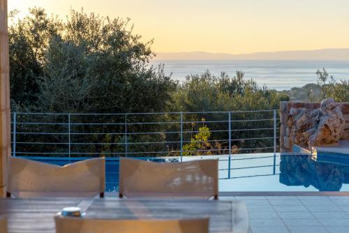 a view of the ocean from the balcony of a house at Trochalo Villas 2 in Stoupa