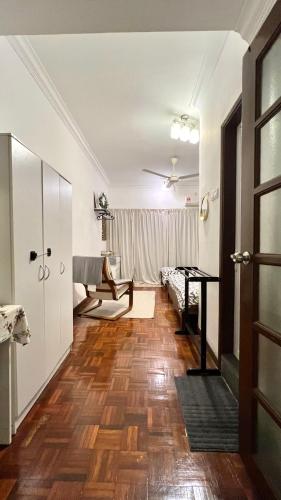 a living room with a table and a piano at The Hill Regency in Bentong