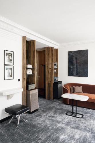 a living room with a couch and a table at Hotel Les Bains Paris in Paris