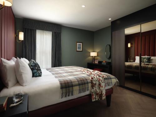 a hotel room with a bed and a window at The Other House South Kensington in London