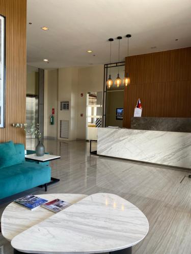 a living room with a blue couch and a table at AVIDA ATRIA Tower 3 in Iloilo City