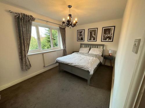 a bedroom with a bed and a window at Cosy home in Warrington in Great Sankey