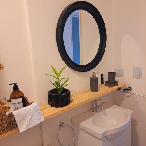 a bathroom with a mirror and a sink at Alojamientos Cordoba - Cañada in Córdoba