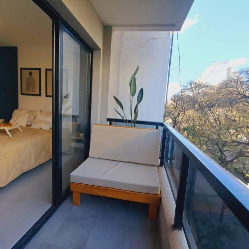 a room with a bed and a chair on a balcony at Alojamientos Cordoba - Cañada in Córdoba