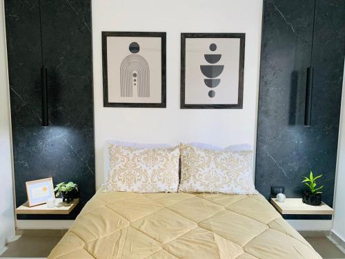 a bedroom with a bed with two pictures on the wall at Alojamientos Cordoba - Cañada in Córdoba