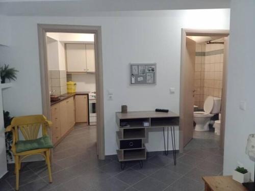 a kitchen with a desk and a toilet in a room at Makis rooms C in Missolonghi