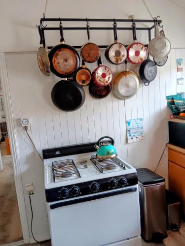 a kitchen with pots and pans hanging above a stove at El Carmel in San Diego