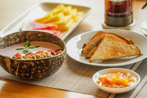 a table with a bowl of soup and a plate of toast at Tityra Lodge in Monteverde Costa Rica