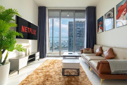 a living room with a couch and a large window at Fully-Equipped Luxury Condo in Central Ho Chi Minh with Downtown and River View in Ho Chi Minh City