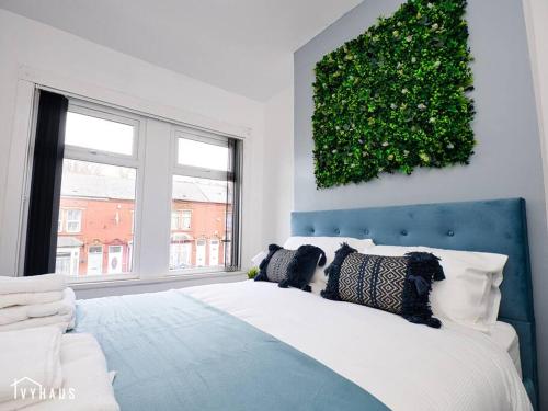 a bedroom with a large white bed with a green wall at BIRMINGHAM HOME : STYLISH : WELCOMES ALL in Birmingham