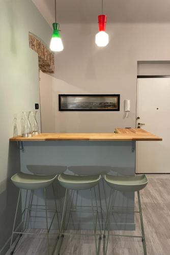 a kitchen with a counter with stools under it at CasaBolla in Genova