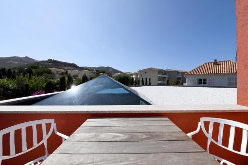 a view of a swimming pool from the balcony of a house at Campo Di Fiori, Maisons de Charme in Calvi