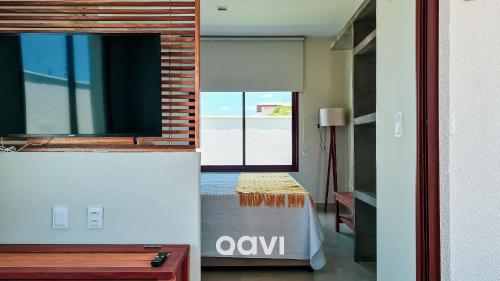 a living room with a table and a window at Villa Makani no Shamballa by Qavi in São Miguel do Gostoso