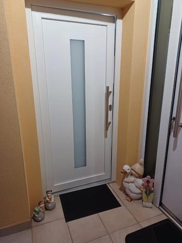 a bathroom door with a mirror and a tiled floor at Ferienwohnung Neli am Rhein in Rheinbrohl