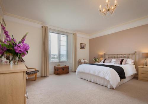 a bedroom with a large bed and a large window at Salty House Shaldon in Shaldon