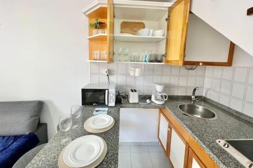 a kitchen with two white plates on a counter at Bungalow playmar 24 in Maspalomas