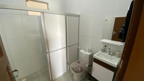 a bathroom with a shower and a toilet and a sink at Chácara Paraíso do Rio em Aracaju in Aracaju
