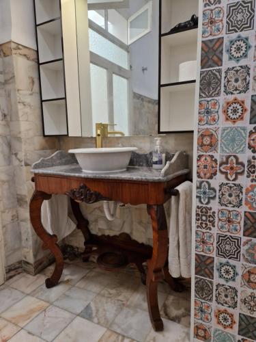 a bathroom with a sink and a mirror at Mont' Sobro House in Évora